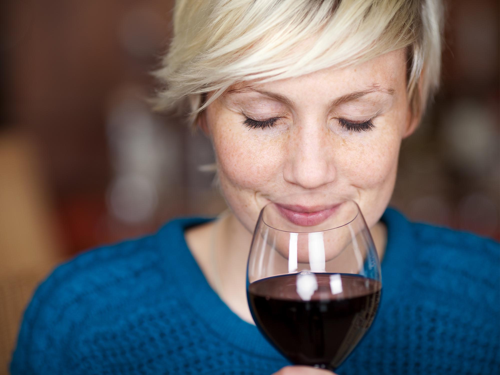 Woman enjoying a glass of red wine.