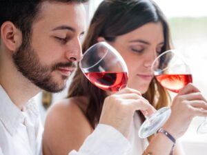 man and woman smelling wine