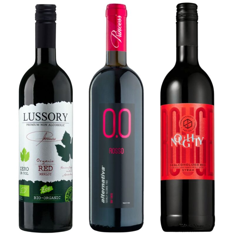 Three bottles of non-alcoholic red wine from Noughty, Lussory, and Princess standing side-by-side on a white background