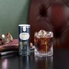 Single can of Lyre’s American Malt and Cola with cola on ice in rocks glass