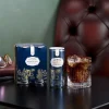 Lifestyle shot of Lyre’s American Malt and Cola 4 pack with cola highball on table