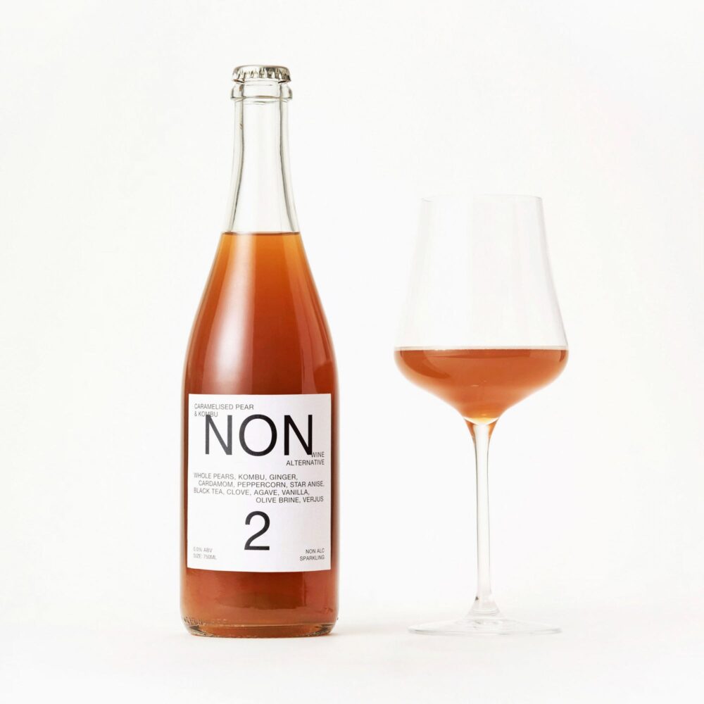 NON 2 Caramelised Pear & Kombu 750ml next to poured glass
