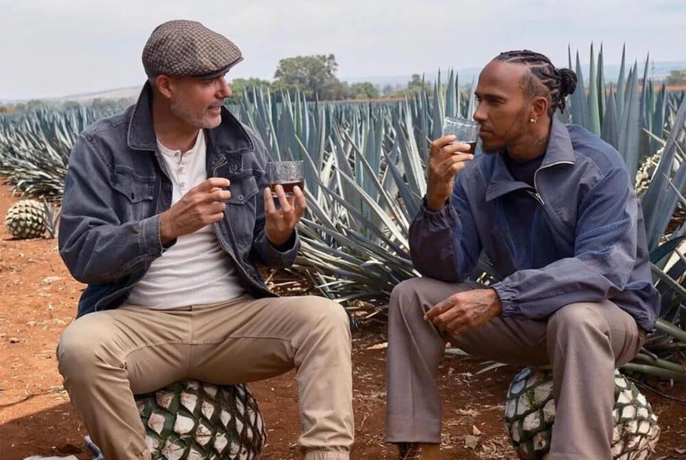 Lewis Hamilton and Dr. Iván Saldaña drinking Almave with backdrop of Agave plants
