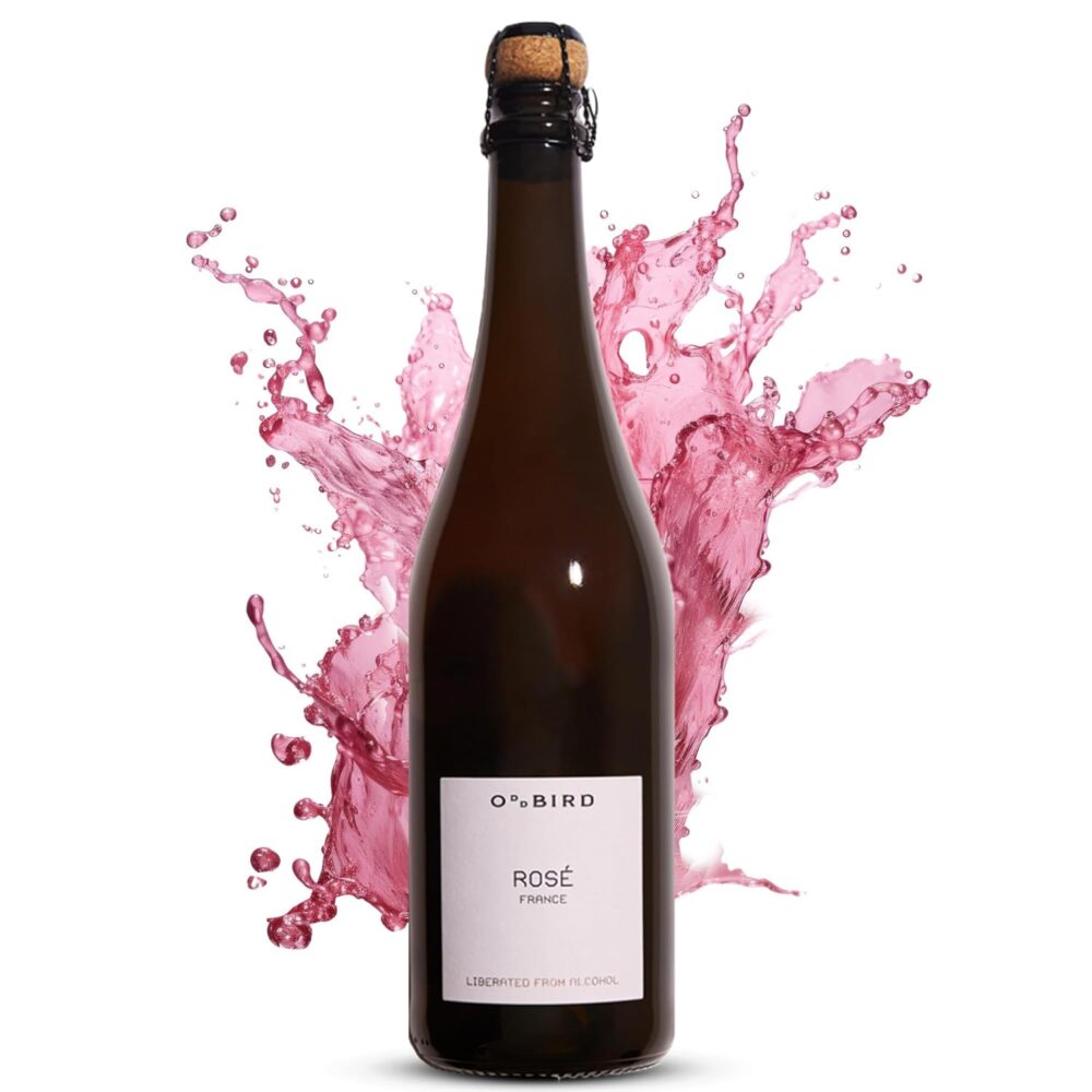 A full bottle of Oddbird Sparkling Rosé with a dramatic pink splash in the background, symbolizing vibrant flavor and festive energy.
