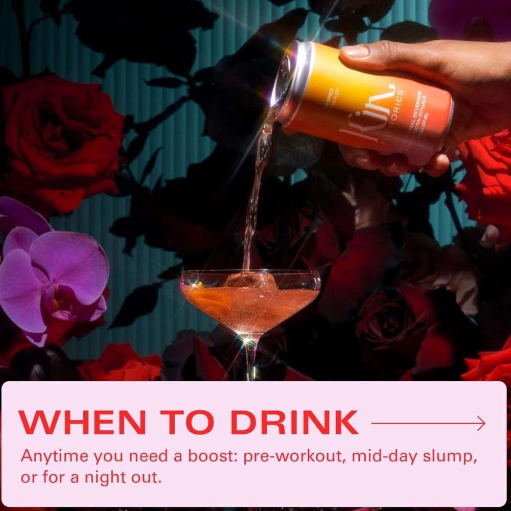 Kin Euphorics Spritz being poured into cocktail glass surrounded by flowers