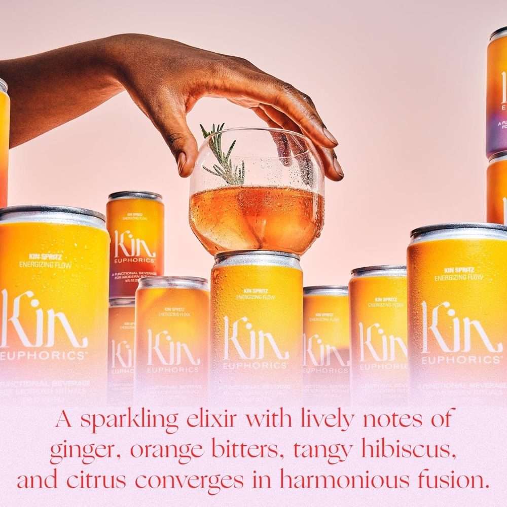 Kin Spritz cocktail with rosemary garnish surrounded by cans