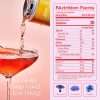Kin Spritz beverage being poured into coupe glass with visible nutrition facts panel