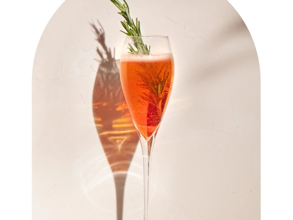 non alcoholic negroni sbagliato cocktail with Wilfreds aperitif served in flute glass with rosemary garnish