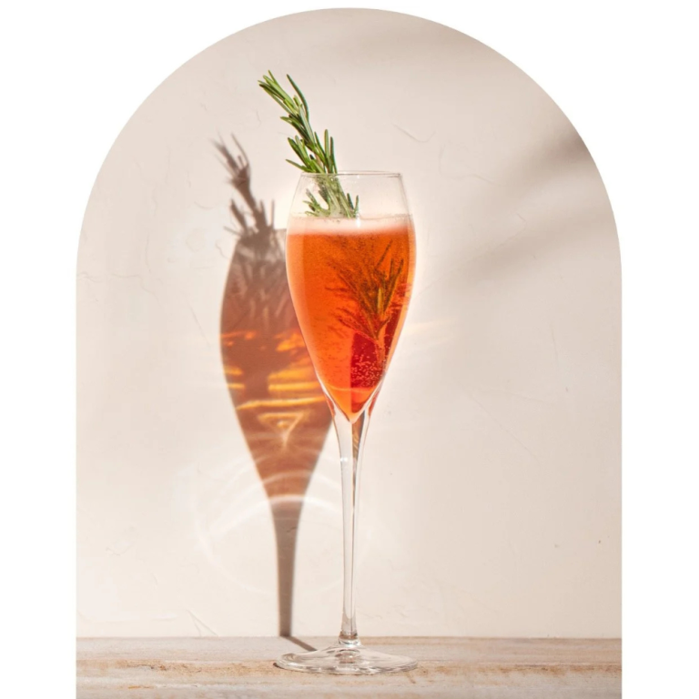 non alcoholic negroni sbagliato cocktail with Wilfreds aperitif served in flute glass with rosemary garnish